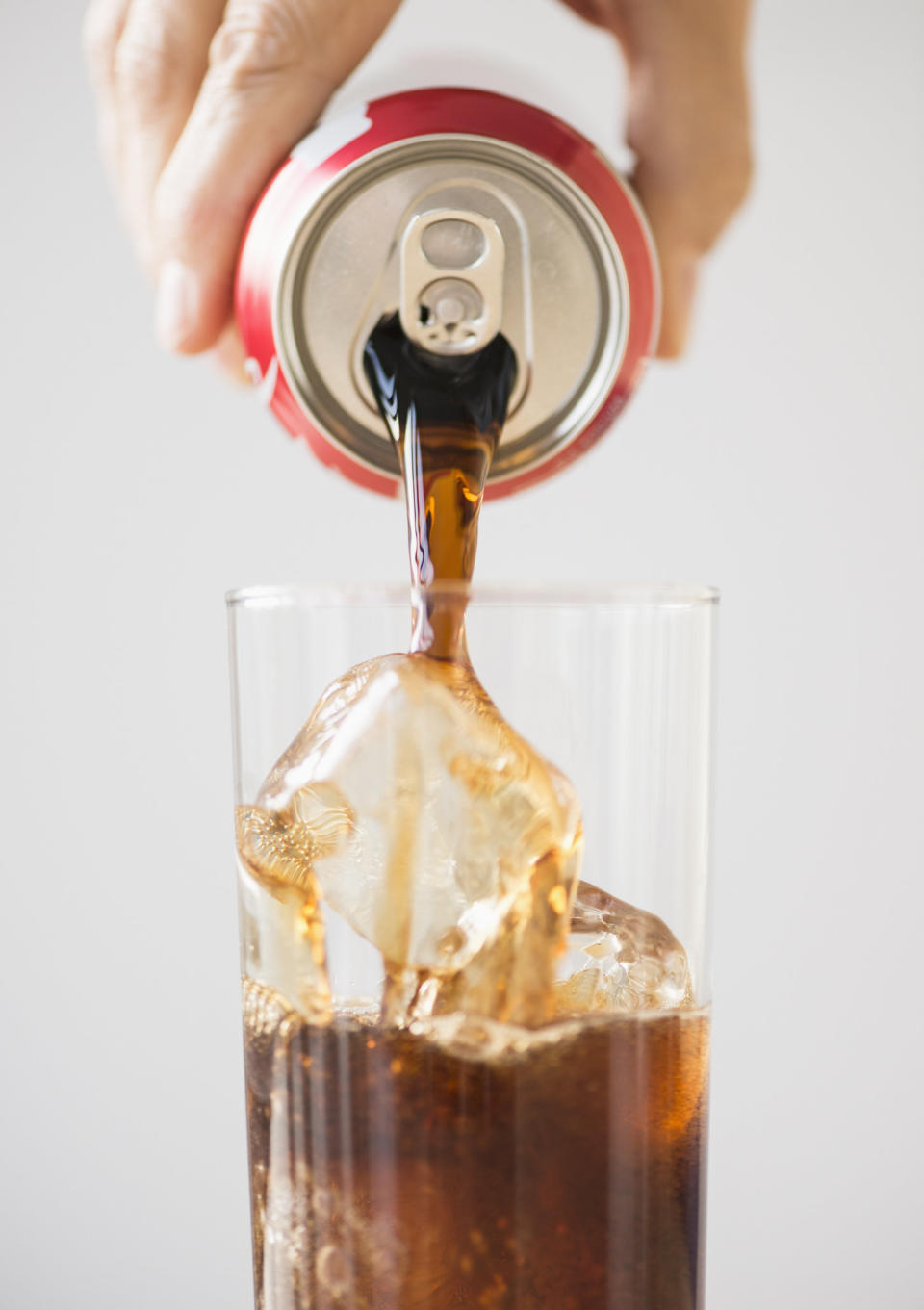 Pouring a soda over ice