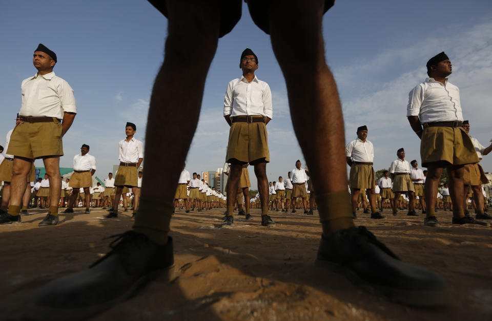 FILE - In this April 10, 2016, file photo, members of Hindu nationalist Rashtriya Swayamsevak Sangh (RSS) stand during Varsh Pratipada festival, the Hindu New Year in Ahmedabad, India. For the group, Indian civilization is inseparable from Hinduism. (AP Photo/Ajit Solanki,file)