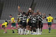 Fiji players huddle up at the start of their men's rugby sevens quarterfinal match against Australia, at the 2020 Summer Olympics, Tuesday, July 27, 2021 in Tokyo, Japan. (AP Photo/Shuji Kajiyama)