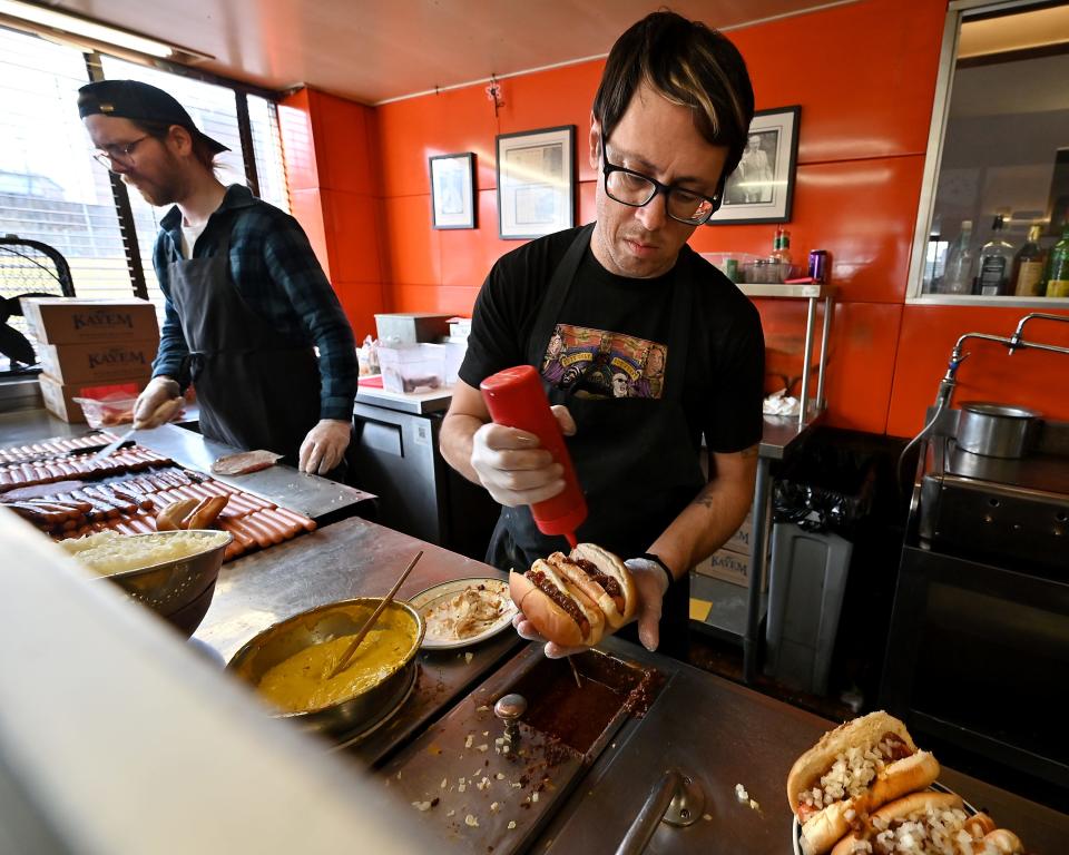 Eric Yankus-Franco, right, and Josh Holden work the grill and prep station at George's Coney Island Hot Dogs.