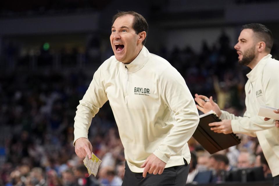 FILE - Baylor head coach Scott Drew instructs his team in the second half of a second-round game against North Carolina in the NCAA college basketball tournament in Fort Worth, Texas, Saturday, March, 19, 2022. If the latest spasm of conference realignment in college sports was supposed to spell doom for the Big 12 or Pac-12 — or for any other conference, for that matter — somebody forgot to tell the basketball coaches. (AP Photo/Tony Gutierrez, File)