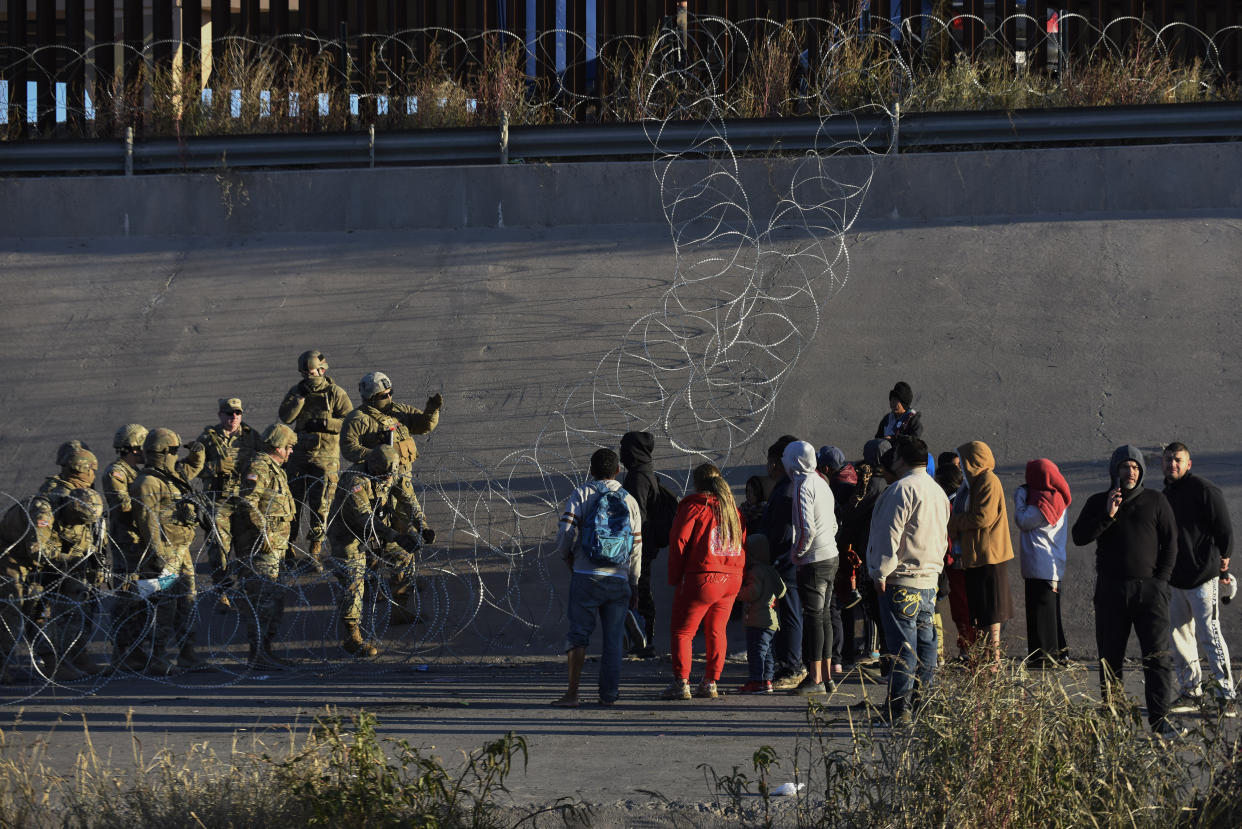 U.S. military stop migrants from crossing into El Paso, Texas, seen from Ciudad Juarez, Mexico, Tuesday, Dec. 20, 2022. (AP Photo/Christian Chavez)