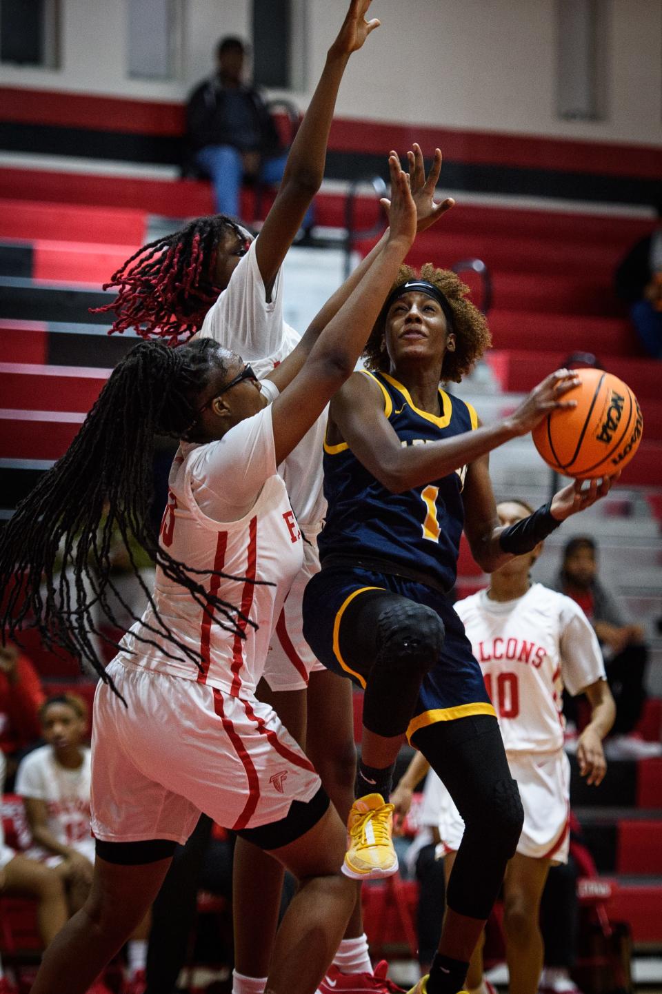 Cape Fear’s Jayda Angel goes up for a shot in front of Seventy-First’s Alani-Skye Wilkerson and Jazmine Bynum during the second quarter on Wednesday, Jan. 31, 2024, at Seventy-First High School.