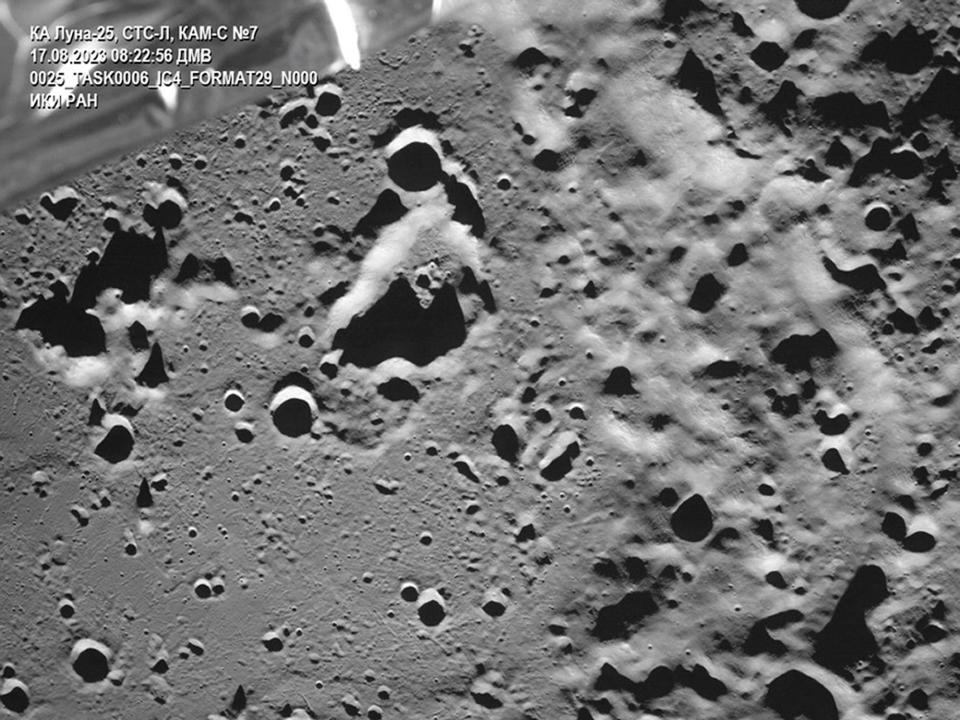 surface of moon grey rocky cratered with luna 25 spacecraft piece visible in upper left corner