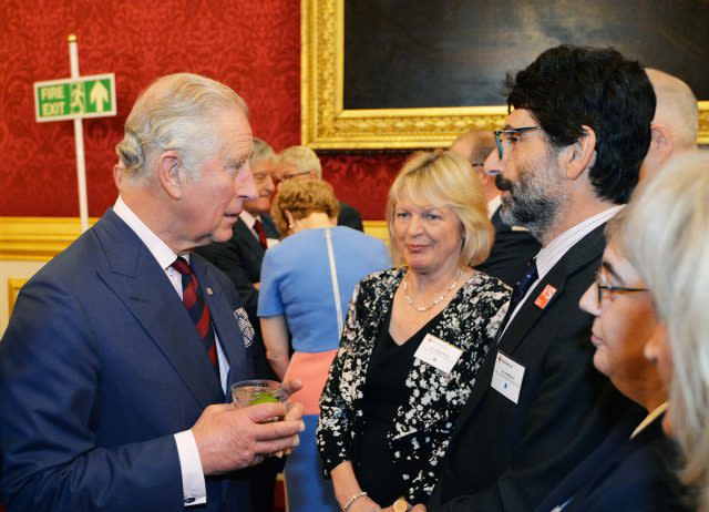 The Prince of Wales talks to guests at a reception for British Red Cross volunteers at St James's Palace