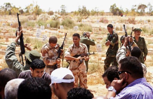 Libyan rebels fire shots in the air at the funeral of a comrade, who was killed in fighting on the outskirts of Brega, in the Libyan rebel stronghold of Benghazi on June 13. Rebels said they suffered heavy losses in eastern Libya after being "tricked" by Moamer Khadafi's forces, as the US pressed Africa to take tougher action against the strongman's regime