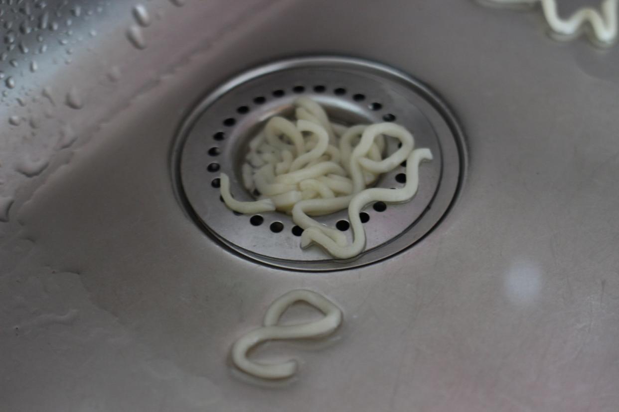 close up of the rest of noodles in kitchen sink after the boiling