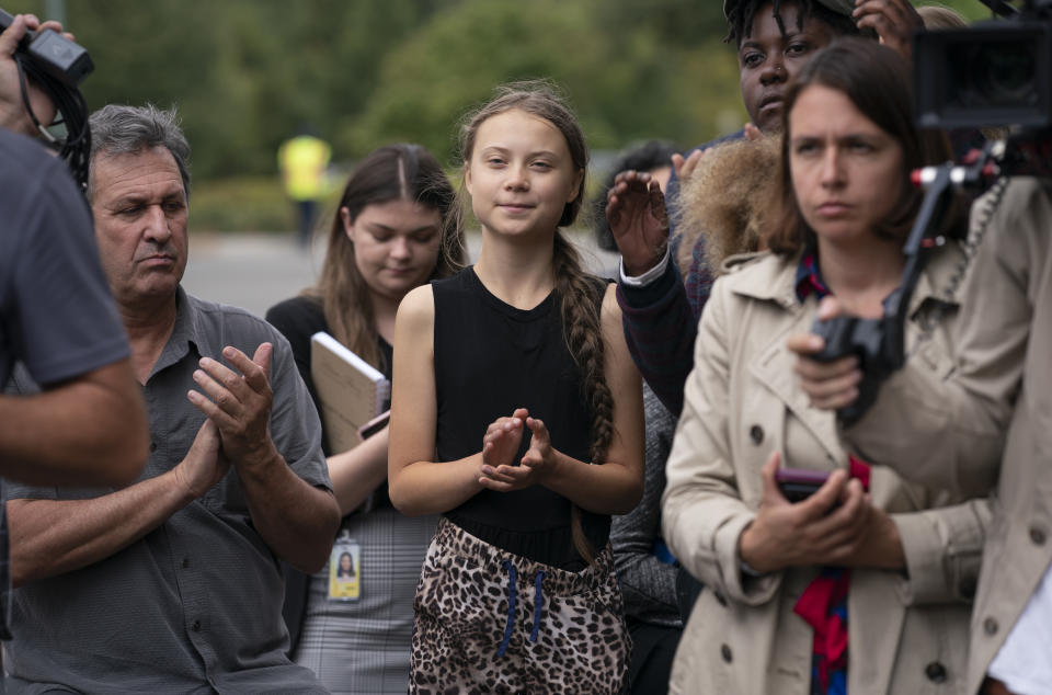 Swedish activist Greta Thunberg, center, who has called on world leaders to step up their efforts against global warming, applauds remarks by Sen. Ed Markey, D-Mass., chairman of the Senate Climate Change Task Force, at a news conference at the Capitol in Washington, Tuesday, Sept. 17, 2019. (AP Photo/J. Scott Applewhite)