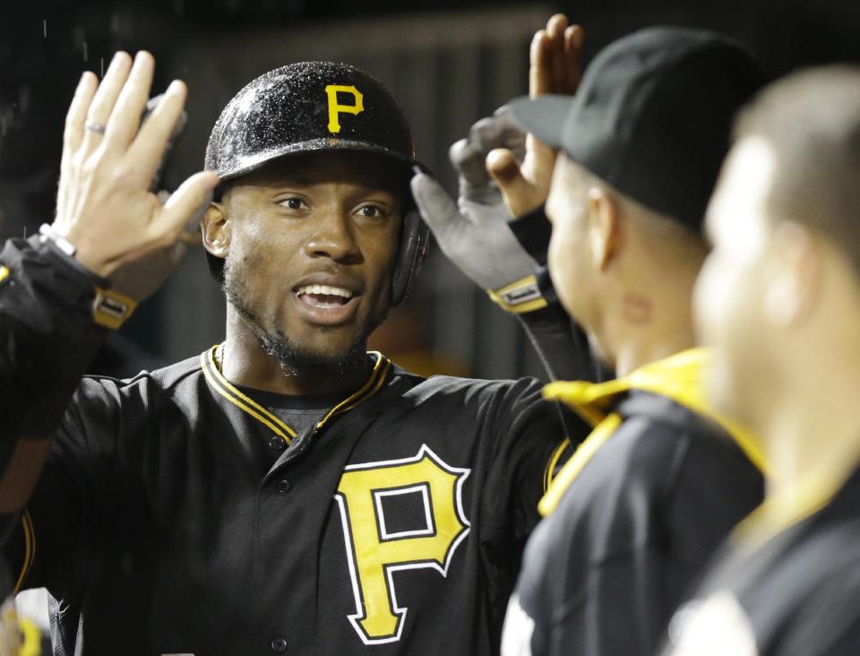 Pittsburgh Pirates' Starling Marte is congratulated after hitting a solo home run off Cincinnati Reds starting pitcher Homer Bailey in the fifth inning of a baseball game, Monday, April 14, 2014, in Cincinnati. (AP Photo/Al Behrman)