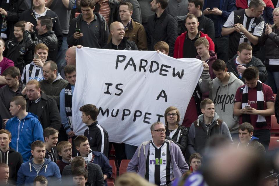 Newcastle United supporters hold up a banner critical of their manager Alan Pardew before their team&#39;s English Premier League soccer match against Stoke at the Britannia Stadium, Stoke, England, Saturday April 12, 2014. (AP Photo/Jon Super)