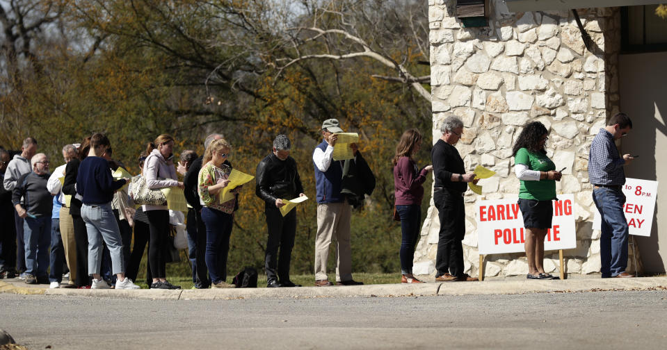 Voters wait in line at an early polling site in San Antonio, Friday, Feb. 28, 2020. Friday is the final day for early voting and Election Day is Tuesday. (AP Photo/Eric Gay)