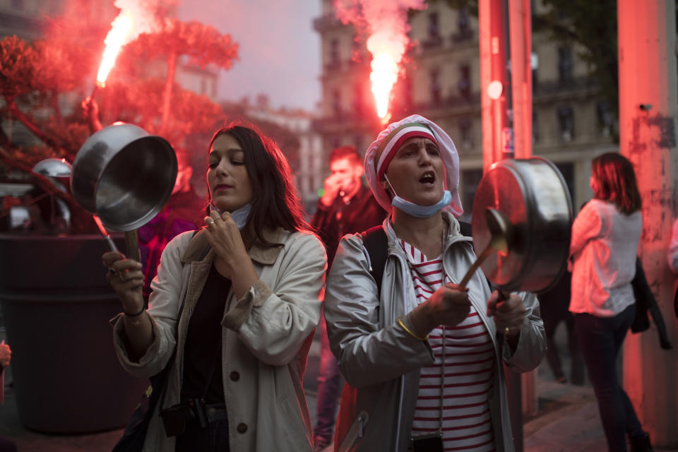 FILE - In this Oct. 2, 2020, file photo, restaurant owners clang spoons and casseroles at a demonstration against restaurant and bar closures in Marseille, southern France. After entire nations were shut down during the first surge of the coronavirus earlier this year, some countries and U.S. states are trying more targeted measures as cases rise again around the world, especially in Europe and the Americas. Restaurant and bar owners in Marseille said the city was unfairly targeted last month for the nation's toughest virus rules at the time. (AP Photo/Daniel Cole, File)