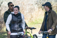 Naomi Biden, second from left, and her fiancé Peter Neal, right, stop on the bikes in Nantucket, Mass., Thursday, Nov. 25, 2021, for President Joe Biden and first lady Jill Biden to pass in a motorcade. (AP Photo/Carolyn Kaster)