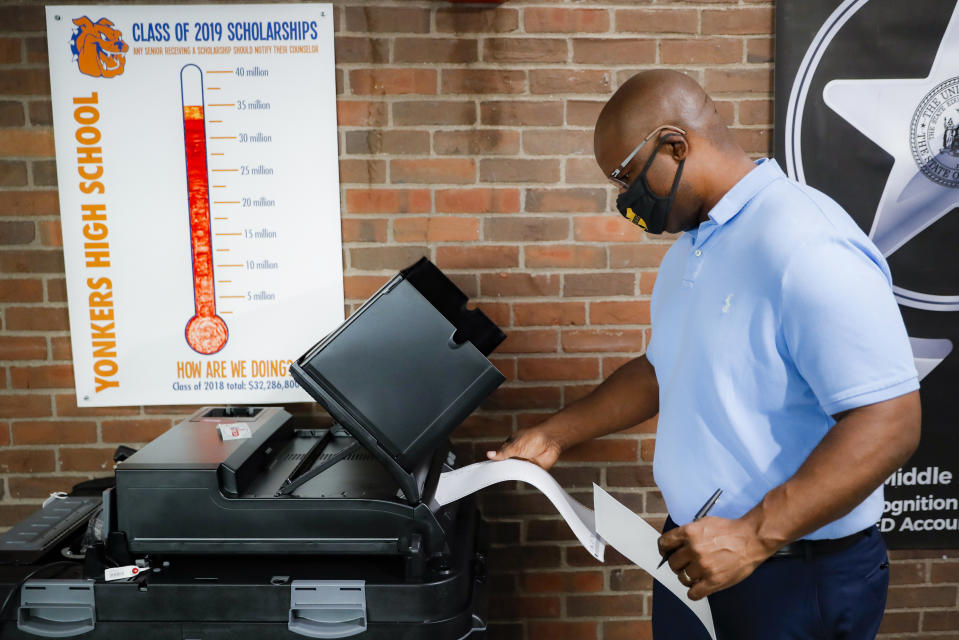Jamaal Bowman votes at a polling station inside Yonkers Middle/High School, Tuesday, June 23, 2020, in Yonkers, N.Y. Bowman is running against veteran Rep. Eliot Engel in the Democratic primary for New York's 16th Congressional District. (AP Photo/John Minchillo)