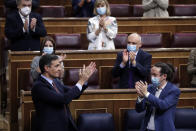 Spain's Prime Minister Pedro Sanchez, bottom left, applauds others as he is applauded by party members during a parliamentary session in Madrid, Spain, Wednesday Oct. 21, 2020. Spanish Prime Minister Pedro Sanchez faces a no confidence vote in Parliament put forth by the far right opposition party VOX. (AP Photo/Manu Fernandez, Pool)