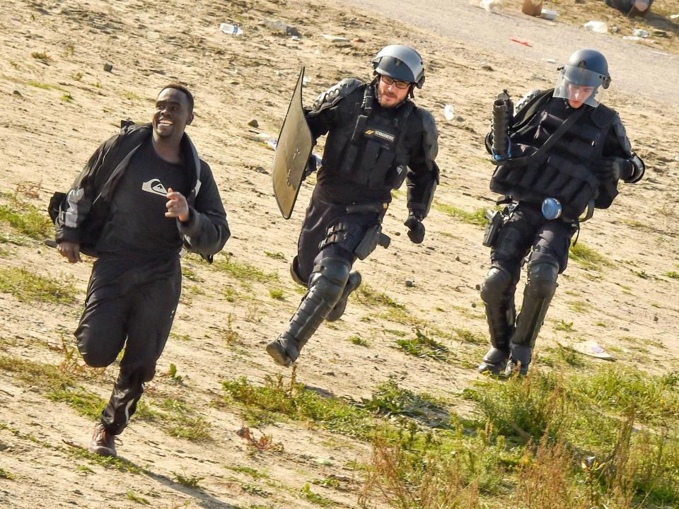 Gendarmes pursue a migrant during the dismantlement of the Jungle in 2016: AFP