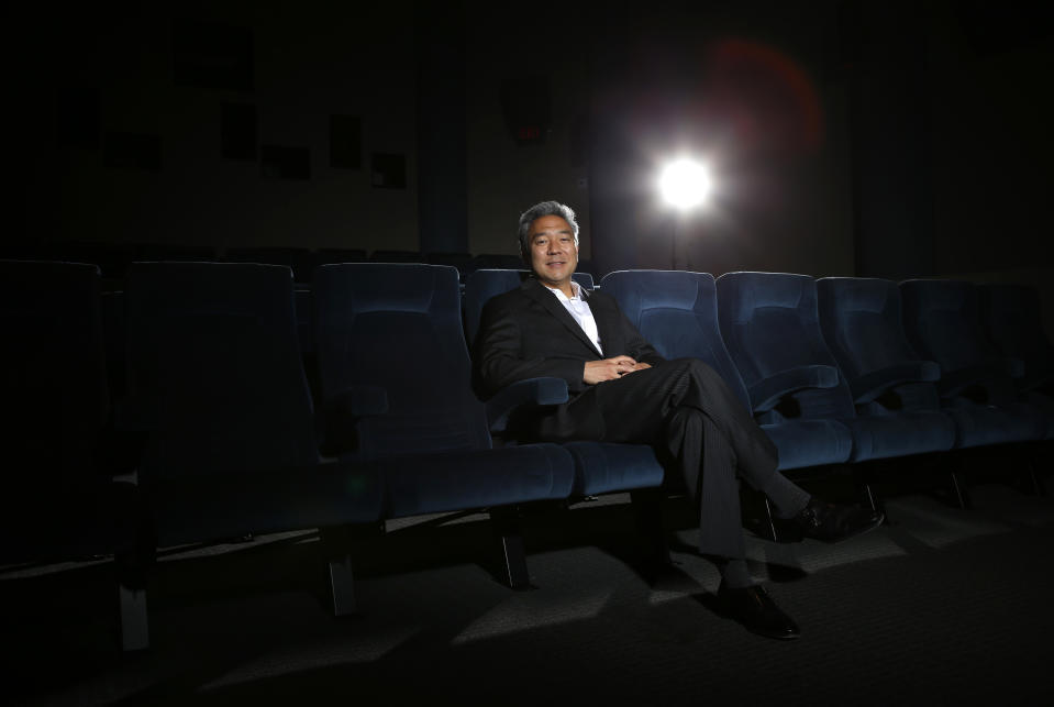In this Wednesday, Feb. 6, 2013, photo, Kevin Tsujihara, poses for photos in a screening room at the Warner Bros. Studios in Burbank, Calif. On Friday, Feb. 28, 2013, Tsujihara, 48, who grew up making deliveries as the son of egg distributors, will become the CEO of Warner Bros. Entertainment. The third-generation Japanese-American will be the first Asian-American to head a Hollywood studio.(AP Photo/Jae C. Hong)