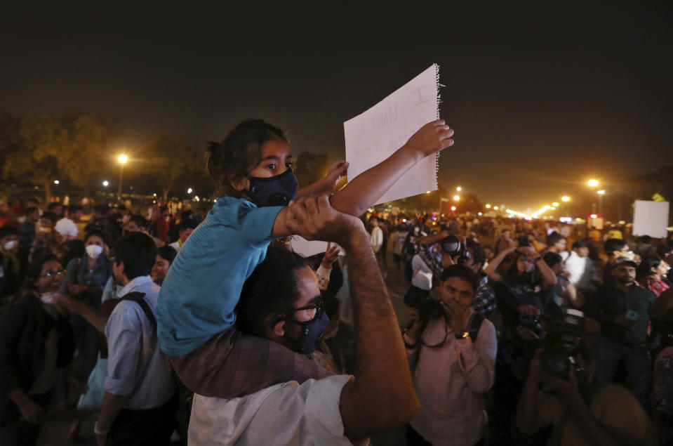 An Indian carries a child on his shoulder and participates in a protest against the alarming levels of pollution in the city, near the India Gate monument in New Delhi, India, Tuesday, Nov. 5, 2019. The 20 million residents of New Delhi, already one of the world's most polluted cities, have been suffering for weeks under a toxic haze that is up to 10 times worse than the upper limits of what is considered healthy. The pollution crisis is piling public pressure on the government to tackle the root causes of the persistent haze. (AP Photo/Manish Swarup)