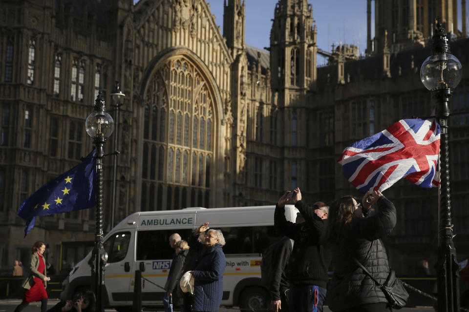 Banderas de la UE y Reino Unido en las afueras de las Casas del Parlamento en Londres. La primera ministra británica, Theresa May logró persuadir a su Gabinete para apoyar el acuerdo preliminar para el Brexit. Ahora debe contar con el apoyo de los parlamentarios de Westminster. (AP Photo/Tim Ireland)