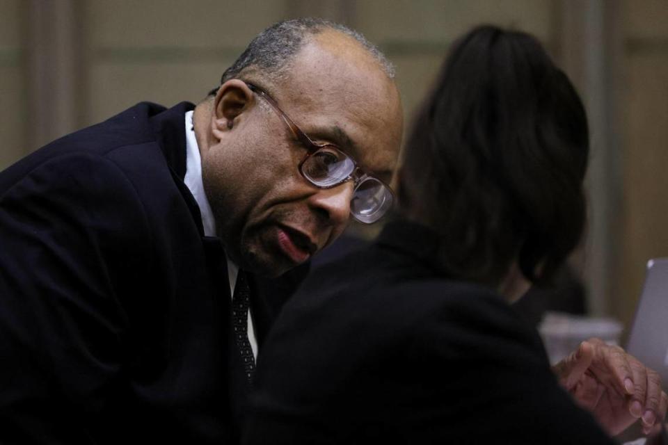 Dale Ewers, who was accused of a 1990 rape and murder in South Beach, talks to one of his attorneys during the opening arguments of his trial at the Richard E. Gerstein Justice Building in Miami, Florida, Monday, February 26, 2024.