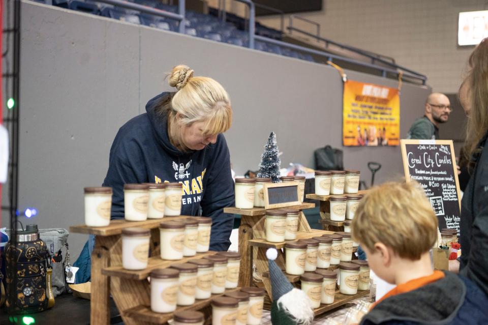 Cereal City Candles displays their products in the holiday market during the Winter Wanderland event at Kellogg Arena on Friday, Dec. 2, 2022.