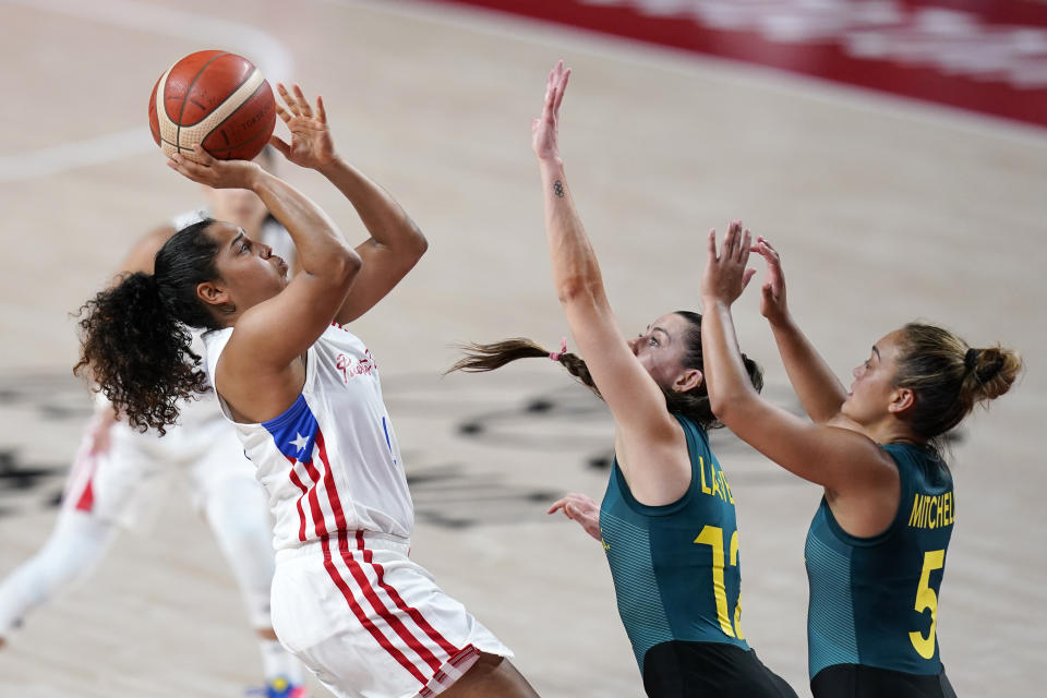 Puerto Rico's Jennifer O'Neill shoots over Australia's Tess Lavey (12) and Leilani Mitchell (5) during a women's basketball preliminary round game at the 2020 Summer Olympics, Monday, Aug. 2, 2021, in Saitama, Japan. (AP Photo/Charlie Neibergall)