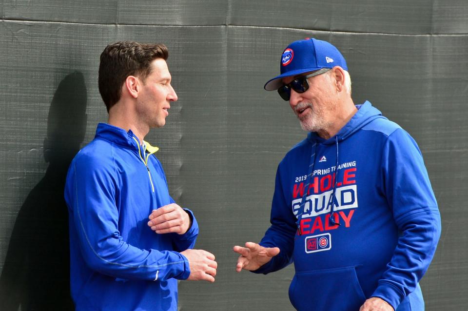 Craig Breslow, left, then the director of strategic initiatives for the Chicago Cubs, chats with then-manager Joe Maddon during spring training in February 2019 in Mesa, Ariz.