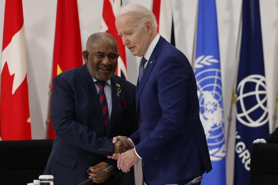 US president Joe Biden (R) greets Comoros president Azali Assoumani at a working session during the G7 Leaders' Summit in Hiroshima (POOL/AFP via Getty Images)