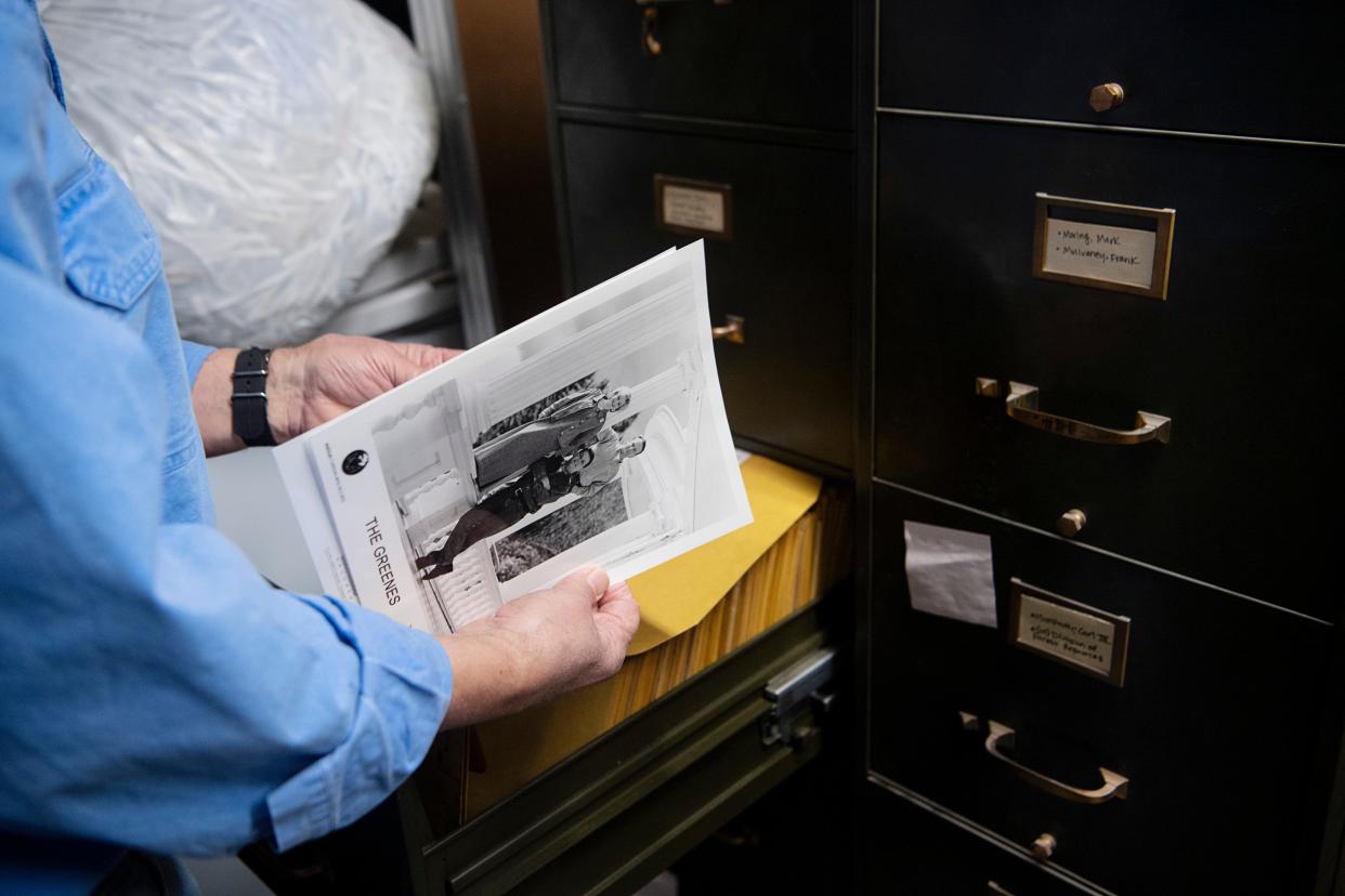 Gene Hyde, Head of Special Collections at UNC Asheville's Ramsey Library, weeds out photographs that were not taken by Asheville Citizen Times’ photographers in the basement of the newspaper’s building, January 29, 2024.