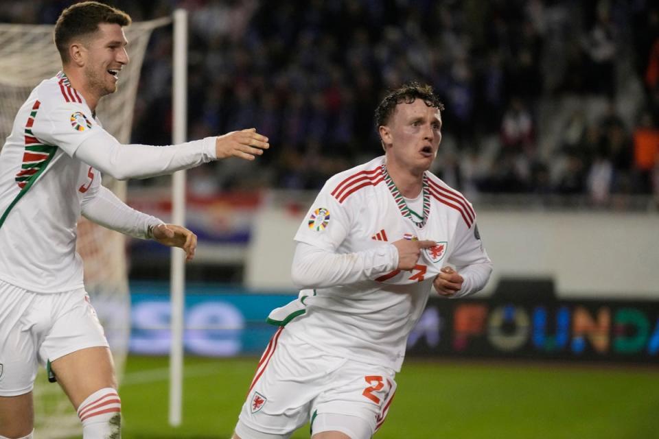 Nathan Broadhead, right, celebrates scoring Wales’ equaliser in their 1-1 Euro 2024 qualifying draw against Croatia (Darko Bandic/AP) (AP)