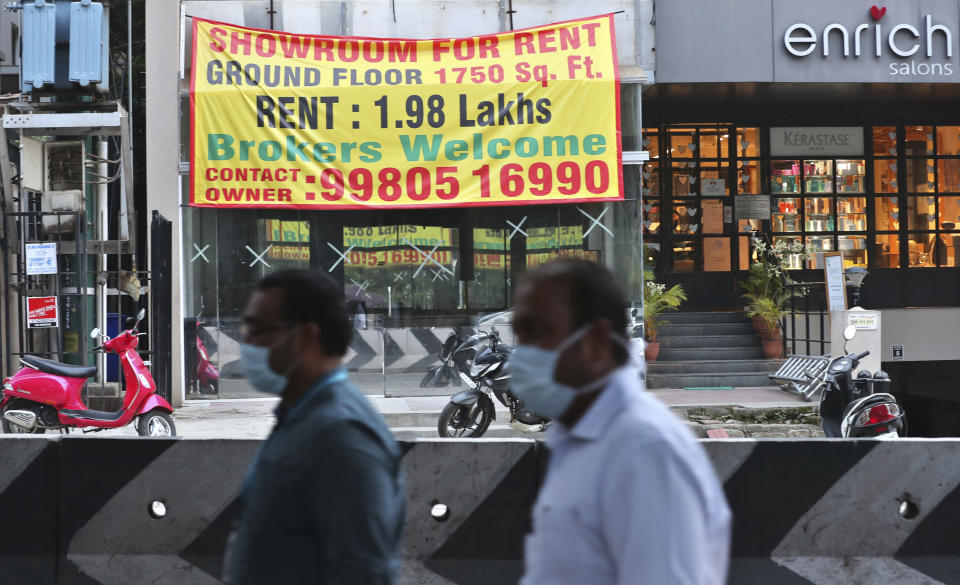 A banner informing about the availability of commercial property is displayed after it was vacated recently due to pandemic in Bengaluru, India, Thursday, Oct. 8, 2020. Thousands of students and professionals who worked for IT companies and lived in the area have moved back to their native places to work remotely. Even as much of the Indian economy has reopened, Bengaluru’s professional workforce is returning to work at a much slower pace than those in most other major cities, raising the risk that the city faces a more protracted recovery. (AP Photo/Aijaz Rahi)