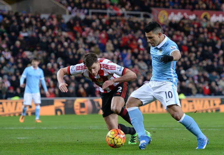 Manchester City's striker Sergio Aguero (R) shoots past Sunderland's defender Billy Jones to score the opening goal of the English Premier League match in Sunderland, on February 2, 2016