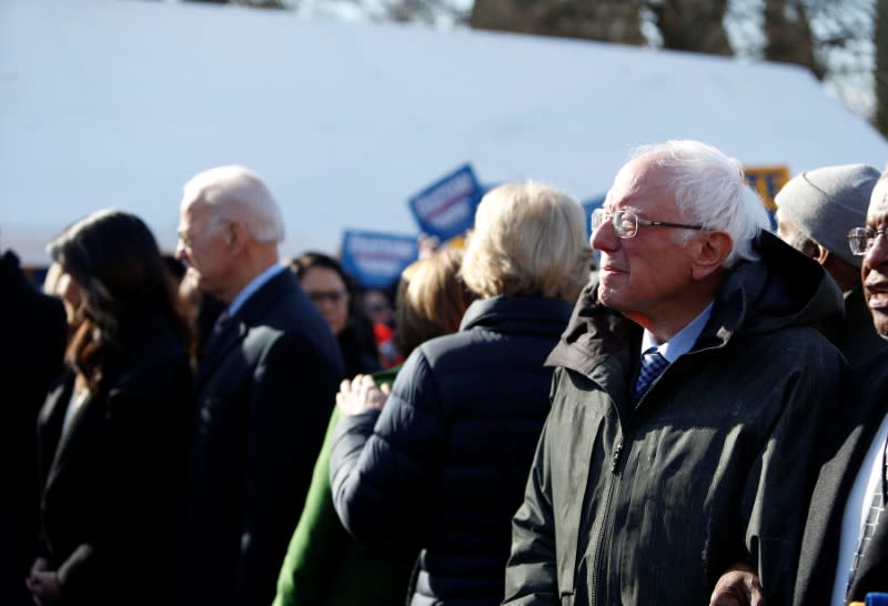 Seven of the Democratic US Presidential candidates walk arm-in-arm with local African-American leaders during the Martin Luther King Jr. (MLK) Day Parade in Columbia