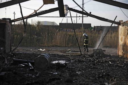 A French fireman walks near debris the day after a fire destroyed large swathes of the Grande-Synthe migrant camp near Dunkirk in northern France April 11, 2017 following skirmishes on Monday that injured several people. REUTERS/Pascal Rossignol