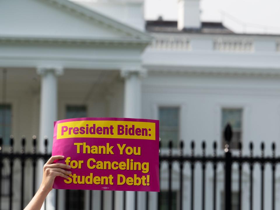 George Washington University student Kai Nilsen and other student loan debt activists rally outside the White House a day after President Biden announced a plan that would cancel $10,000 in student loan debt for those making less than $125,000 a year in Washington, DC, on August 25, 2022.