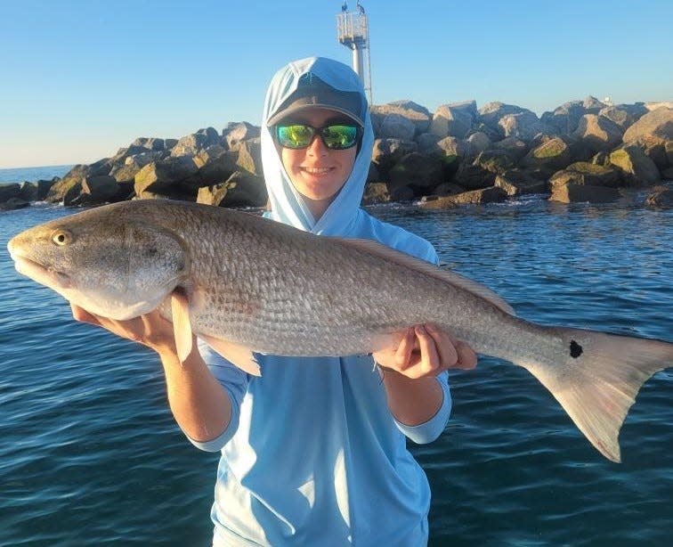 Jack Glazier with a slightly oversized redfish he caught at Ponce Inlet.