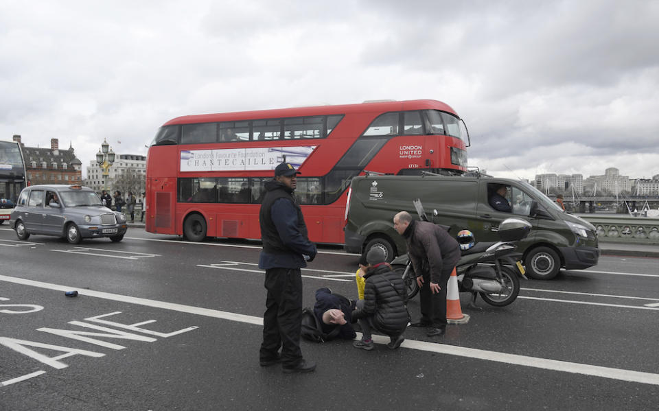 A man lies injured after a shottingt incident on Westminster Bridge in London, March 22, 2017.