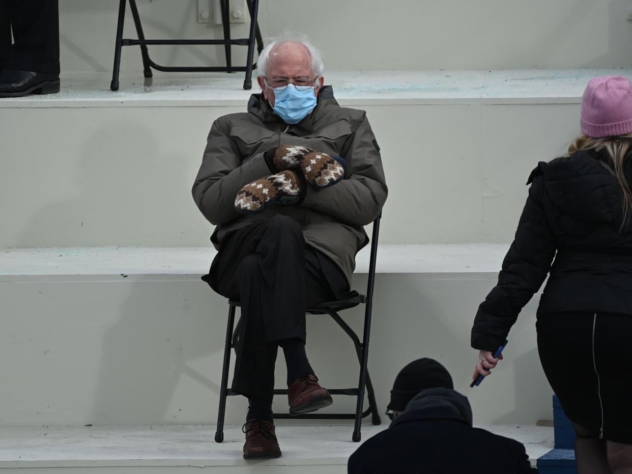 Bernie Sanders sits in the bleachers on Capitol Hill before Joe Biden is sworn in as the 46th US president on 20 January 2021, at the US Capitol (BRENDAN SMIALOWSKI/AFP via Getty Images)