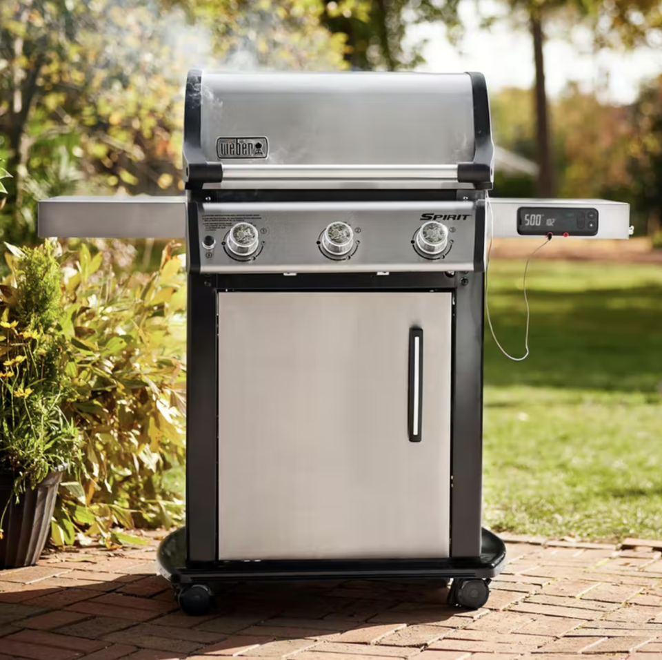 weber Spirit SX-315 Smart Grill in stainless steel in backyard (Photo via Weber)