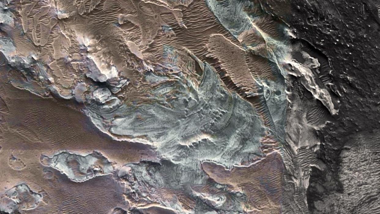  a picture of the landscape of Mars from above showing ice deposits 