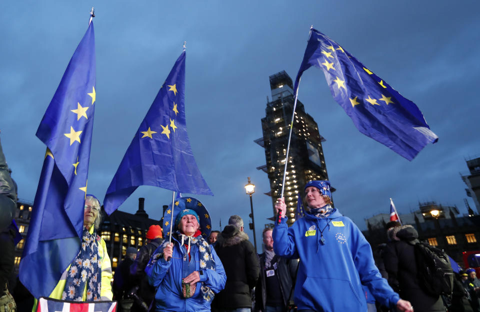 Pro-European demonstrators hold EU flags at Parliament Square in London, Tuesday, Jan. 15, 2019. Britain's Prime Minister Theresa May is struggling to win support for her Brexit deal in Parliament. Lawmakers are due to vote on the agreement Tuesday, and all signs suggest they will reject it, adding uncertainty to Brexit less than three months before Britain is due to leave the EU on March 29. (AP Photo/Frank Augstein)