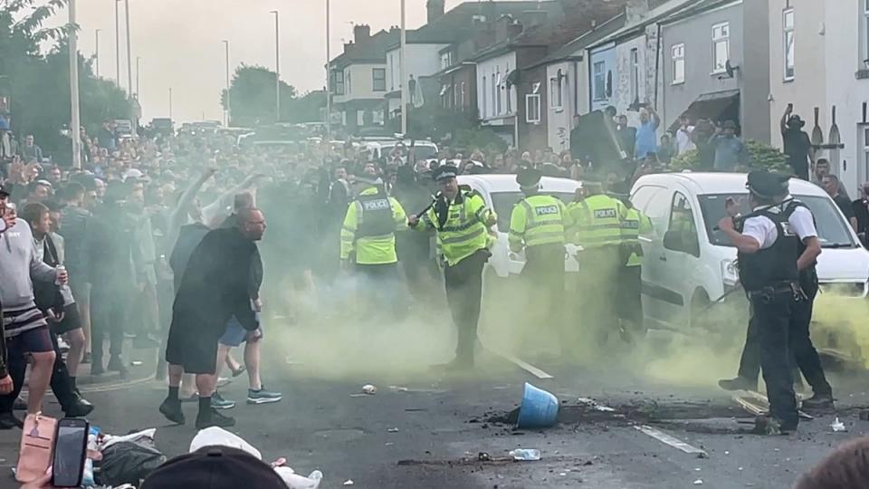 Angry shouts were heard and fireworks were set off during the confrontation (Richard McCarthy/PA Wire)