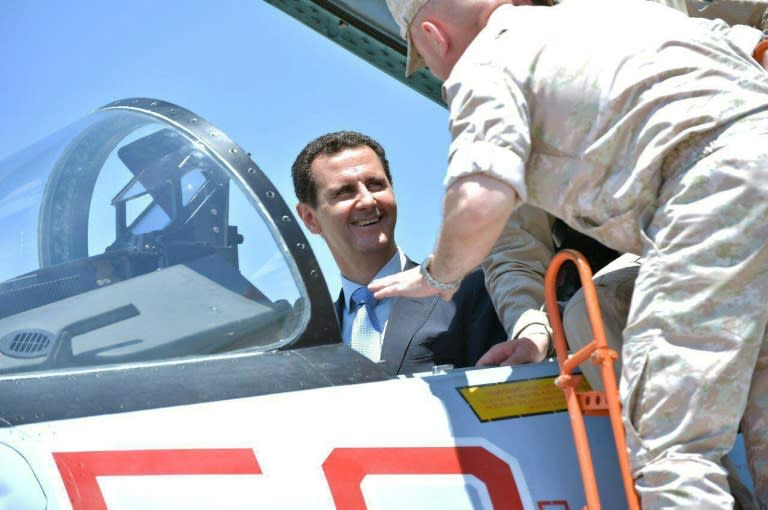 A handout picture released by the Syrian presidency on June 27, 2017 shows President Bashar al-Assad sitting inside a Sukhoi Su-27 during a visit to the Hmeimim military base