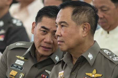 The next Thai national police chief Chakthip Chaijinda (L) talks with Thai national police chief Somyot Pumpanmuang (R) during a religious ceremony near the Erawan shrine, the site of Monday's deadly blast, in central Bangkok, Thailand, August 21, 2015. REUTERS/Athit Perawongmetha