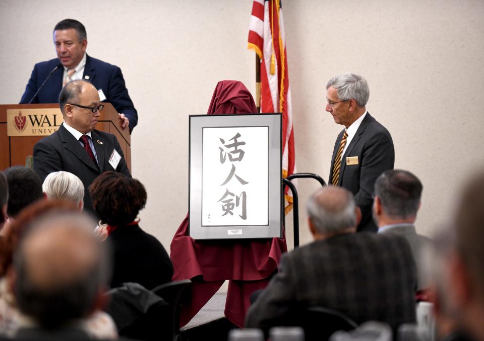 Yoshiaki Maeda, president of Shimadzu U.S., receives a gift from Walsh University President Tim Collins during a dedication for the university's SPARQ Analytical Laboratory of Scientific Excellence, which was outfitted with Shimadzu Scientific Instruments.