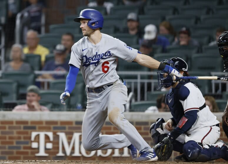 Los Angeles Dodgers' Trea Turner takes off after hitting an RBI single.