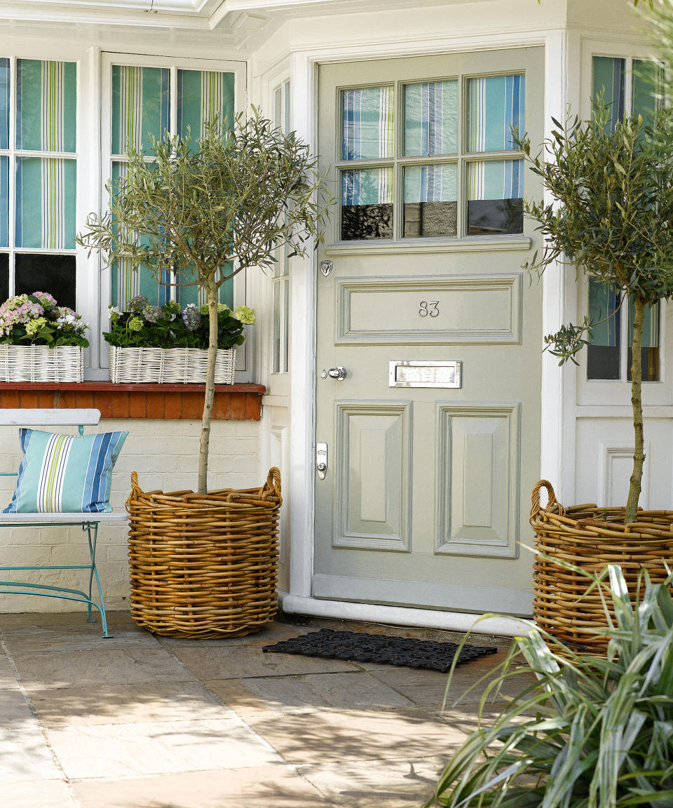 <p> A quick way of switching things up is by experimenting with container gardening ideas, and introducing thoughtfully positioned planters.  </p> <p> Choose pots that work with your overall color scheme in terms of complementing the materials used in the hard landscaping and exterior paintwork. Group them together for maximum impact.  </p> <p> In the front porch idea shown above, a pair of bay trees in matching pots flanking the entrance offer a smart solution.  </p>