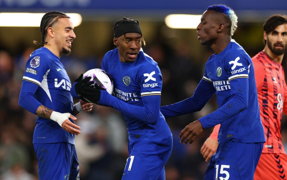 Noni Madueke and Nicolas Jackson of Chelsea argue over a penalty kick during the Premier League match between Chelsea FC and Everton FC at Stamford Bridge on April 15, 2024 in London, England