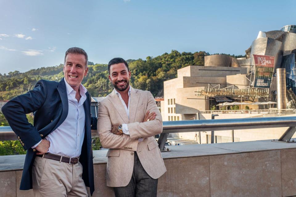 two men standing on a ledge