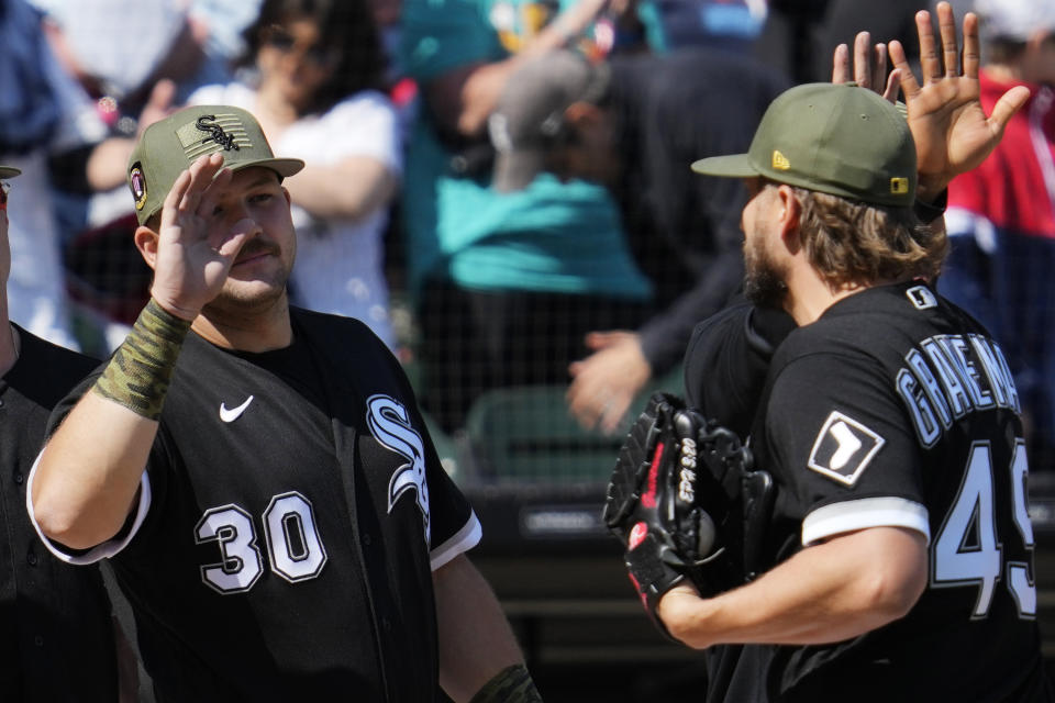 Chicago White Sox's Jake Burger, left, celebrates with relief pitcher Kendall Graveman after the White Sox defeated the Kansas City Royals 5-1 in a baseball game in Chicago, Saturday, May 20, 2023. (AP Photo/Nam Y. Huh)